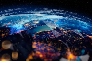 A digital illustration of Earth from space at night, showing glowing city lights across continents connected by luminous network lines, representing global connectivity.